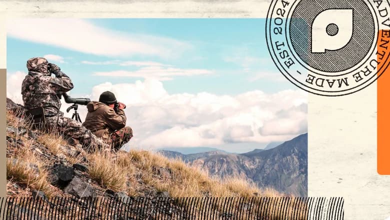 Two hunters glassing the landscape with binoculars and spotting scopes in mountainous terrain