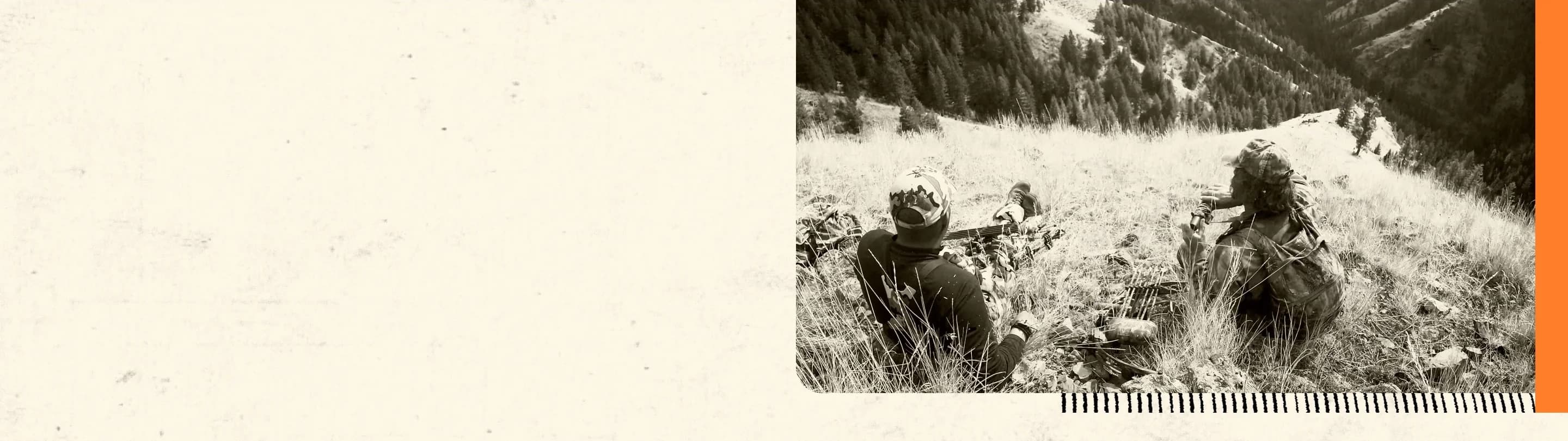 Hunters trekking through snowy mountain terrain with hunting gear